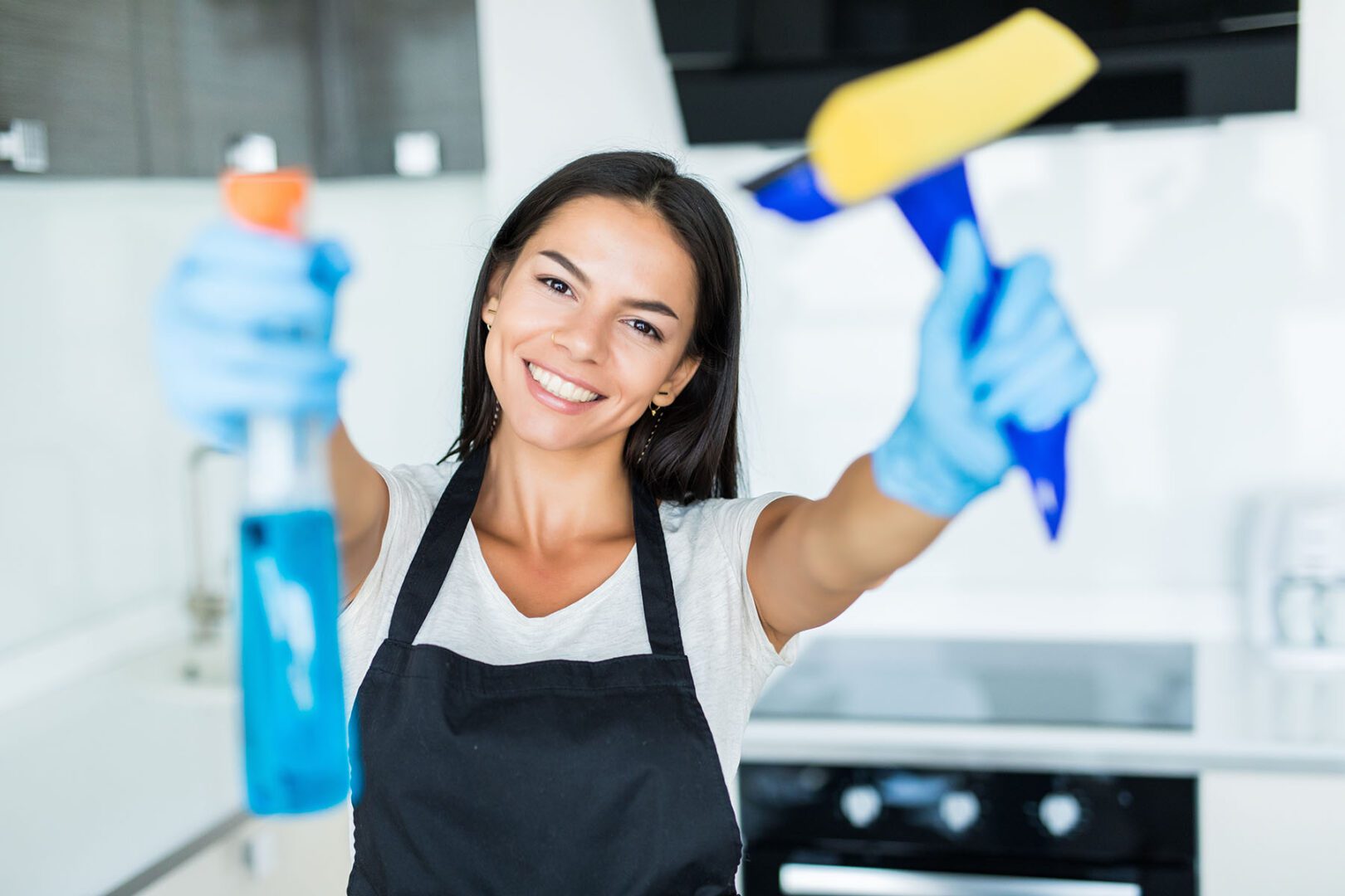 Young woman from a professional cleaning company cleans up at home.